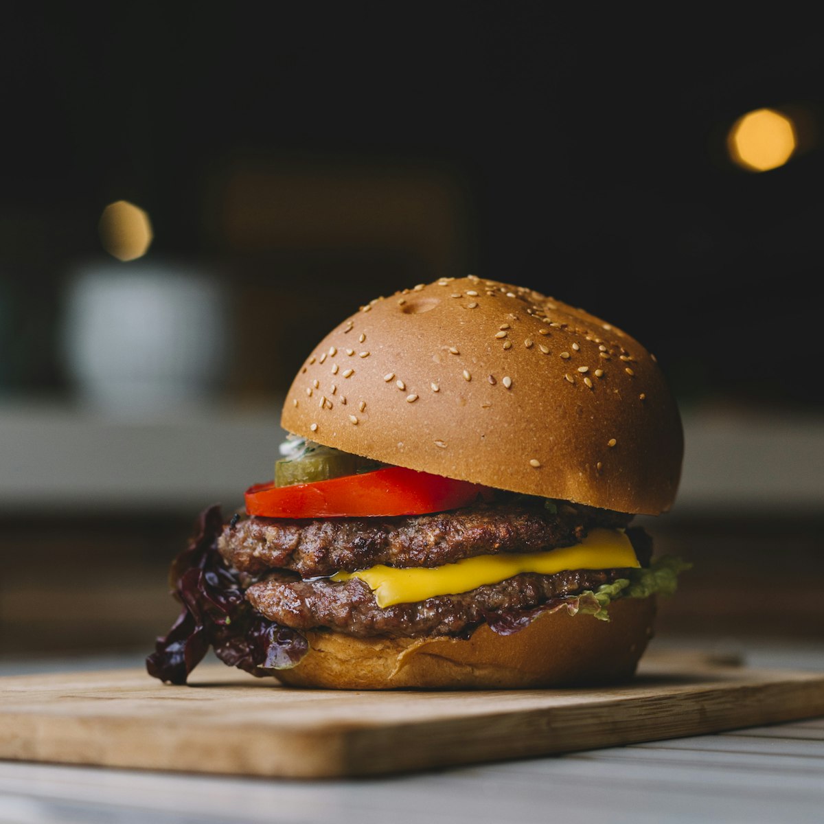Dark moody burger close-up with melted cheese
